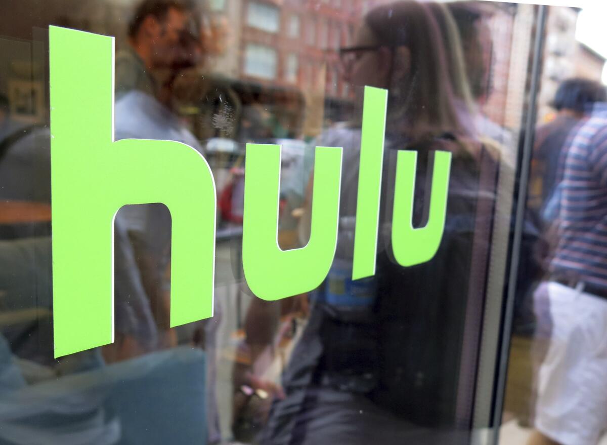 This June 27, 2015, file photo, shows the Hulu logo on a window at the Milk Studios space in New York