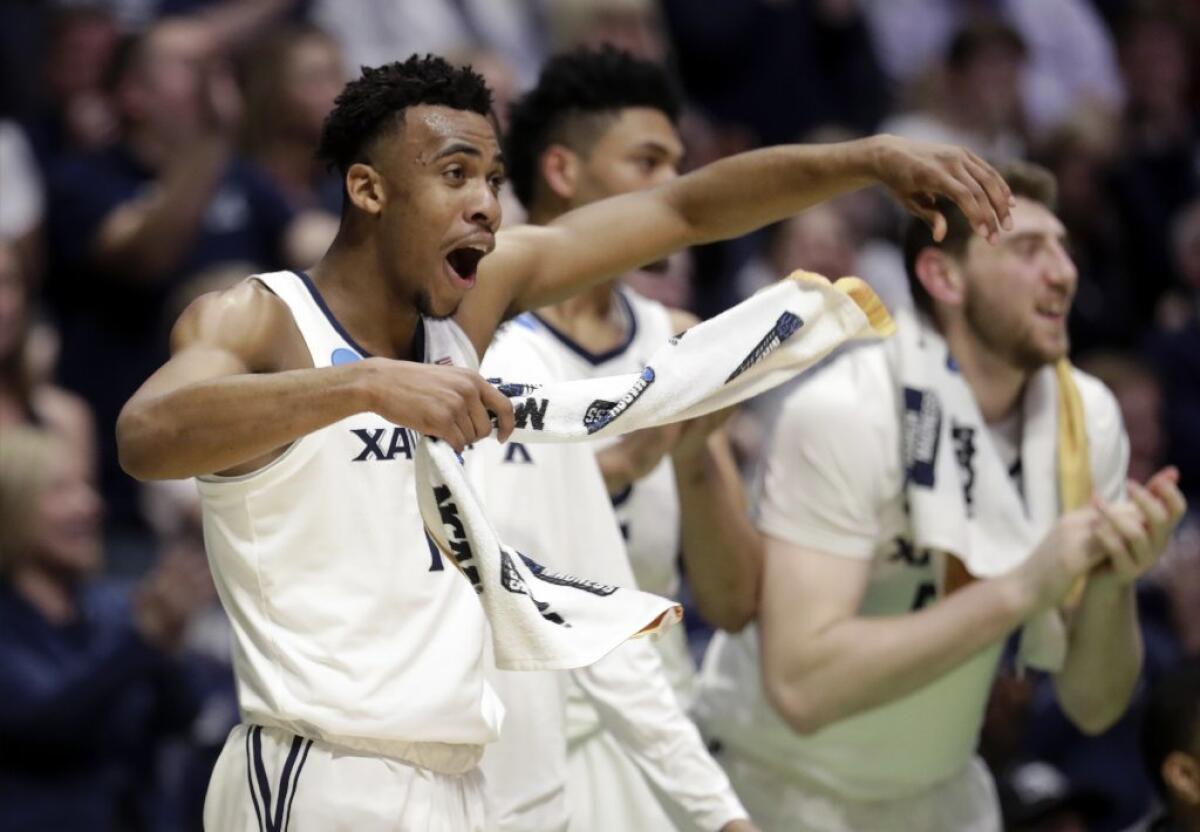 Xavier guard Paul Scruggs reacts from the bench during an NCAA tournament game against Texas Southern.