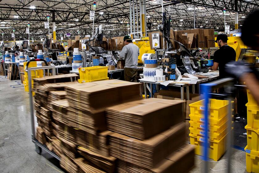 Workers quickly pack items on Cyber Monday at the Amazon Fulfillment Center on November 28, 2016 in San Bernardino, California.