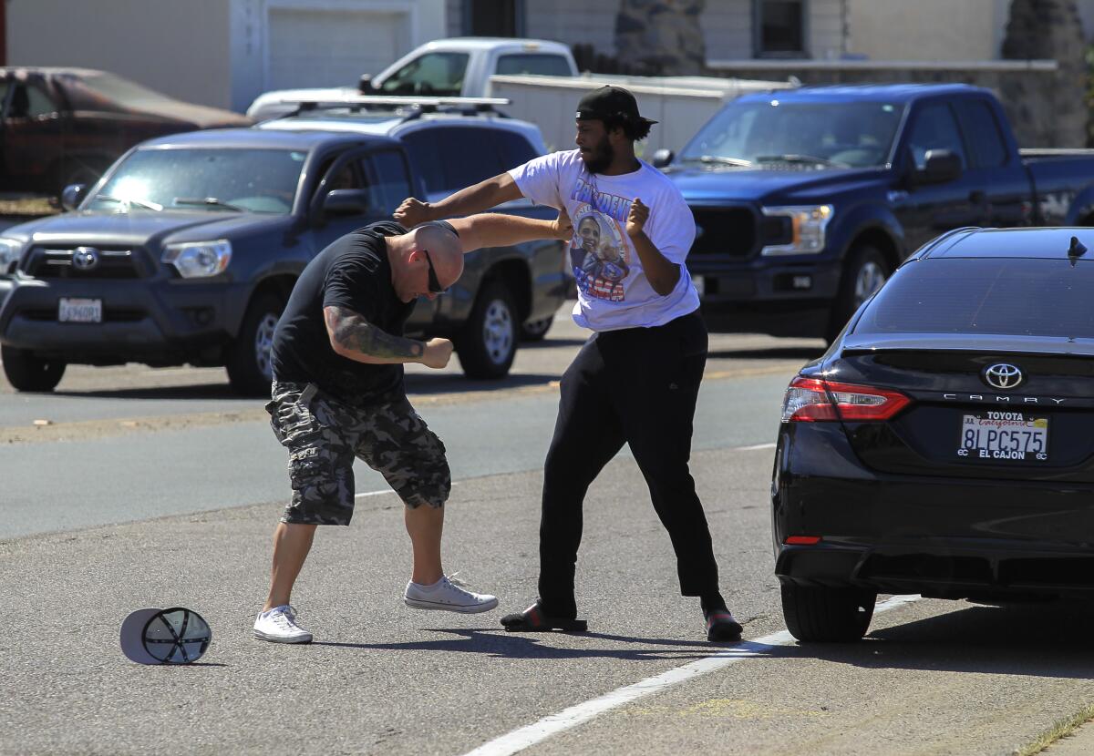 Two men tussle in La Mesa Aug. 1 before a protest march.