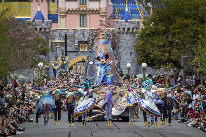 ANAHEIM, CALIF. -- THURSDAY, FEBRUARY 27, 2020: Dancers in vibrant, elaborate costumes join Mickey Mouse, dressed in the ''Sorcerer's Apprentice'' costume from Walt Disney's Fantasia, lead the new daytime parade titled "Magic Happens" on Main Street U.S.A. on Thursday, Feb. 27, 2020 in Anaheim. Disneyland gave the media and Disneyland guests a sneak peak of the parade that will begin running for the general public Friday, Feb. 28. (Allen J. Schaben / Los Angeles Times)