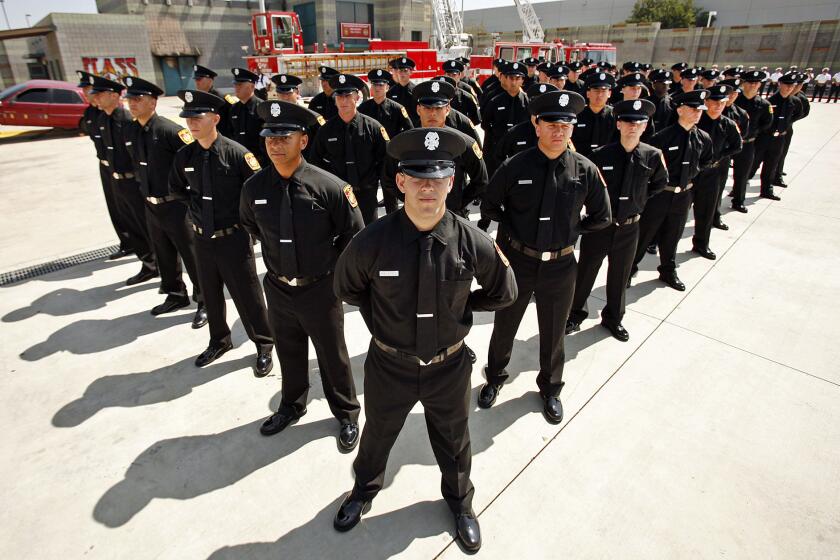 The 58 latest recruits of the Los Angeles Fire Department stand in formation during their graduation ceremony in Panorama City in June.