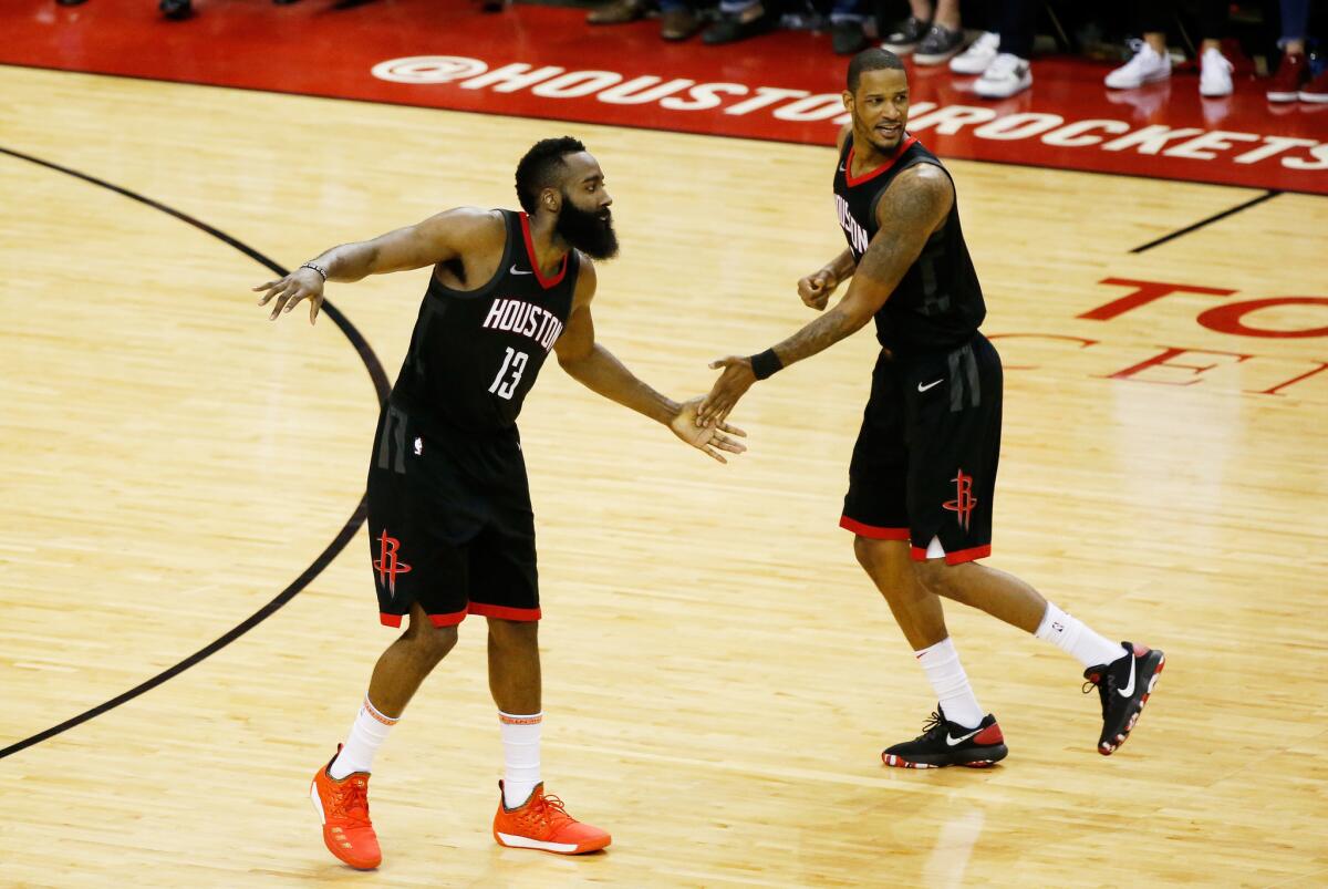 HOUSTON, TX - MAY 16: James Harden #13 and Trevor Ariza #1 of the Houston Rockets react in the fourth quarter against the Golden State Warriors of Game Two of the Western Conference Finals of the 2018 NBA Playoffs at Toyota Center on May 16, 2018 in Houston, Texas.