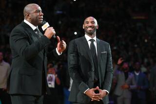 Former Lakers guard Magic Johnson, left, praises Kobe Bryant during a ceremony in 2017.
