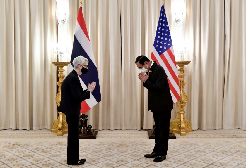 In this photo released by Government Spokesman Office, U.S. Deputy Secretary of State Wendy R. Sherman, left, and Thailand's Prime Minister Prayuth Chan-ocha, right, give the traditional greeting or "wai" at Government House in Bangkok, Thailand, Wednesday, June 2, 2021. (Government Spokesman Office via AP)