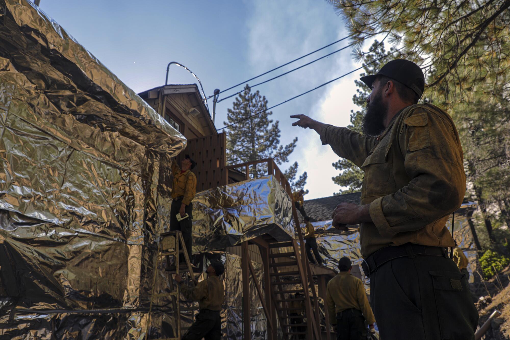 The Bear Divide Hotshots crew wraps the U.S. Forest Service information center in aluminum foil.