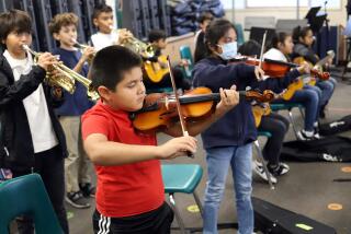 Students from Benjamin Franklin Elementary School learn how to play the mariachi classic "arboles de la barranca" by learning how to play the violin, trumpet and guitar during the Anaheim Elementary School District's, Learning Opportunities Program at Benjamin Franklin Elementary School in Anaheim on Tuesday, December 6, 2022. (Photo by James Carbone)