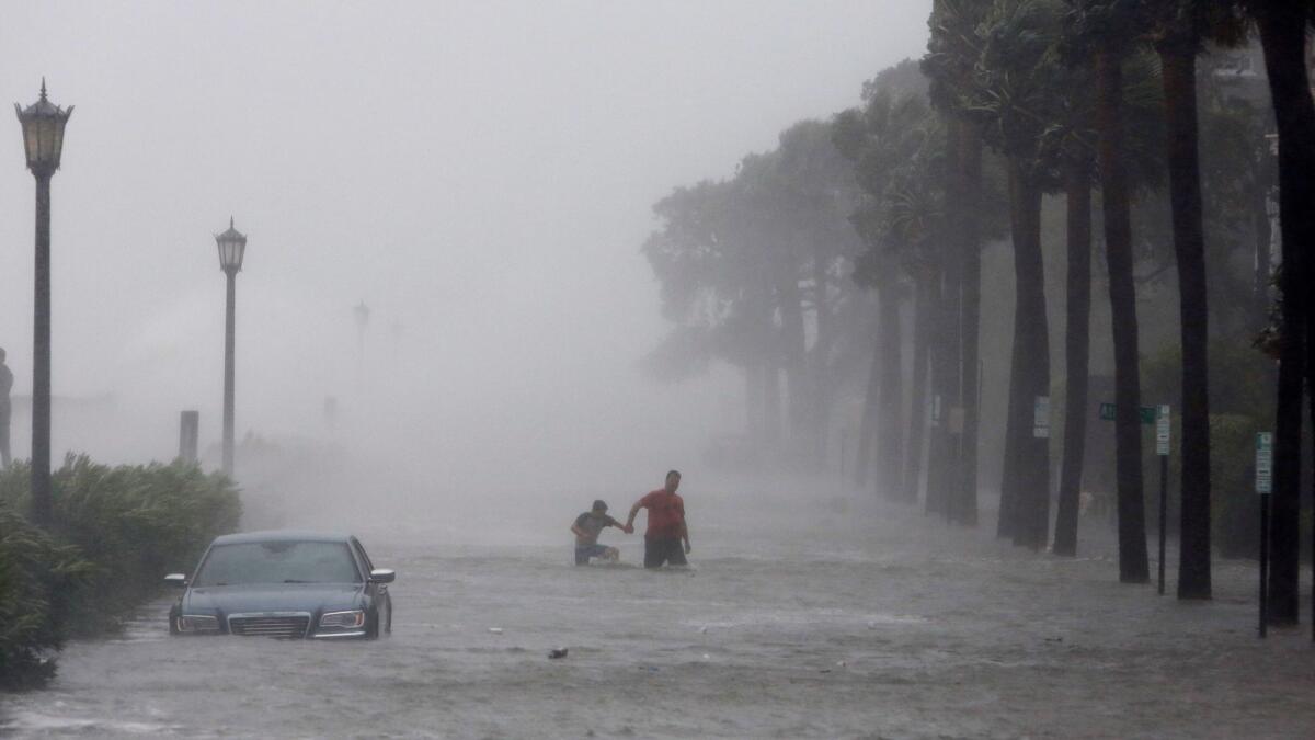 Pedestrians walk in a flooded street as Tropical Storm Irma hits Charleston, S.C. on Sept. 11.