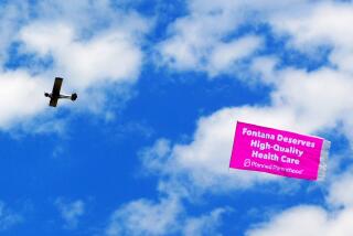 A plane flies over Fontana City Hall in July after the city council blocked the construction of a Planned Parenthood clinic.