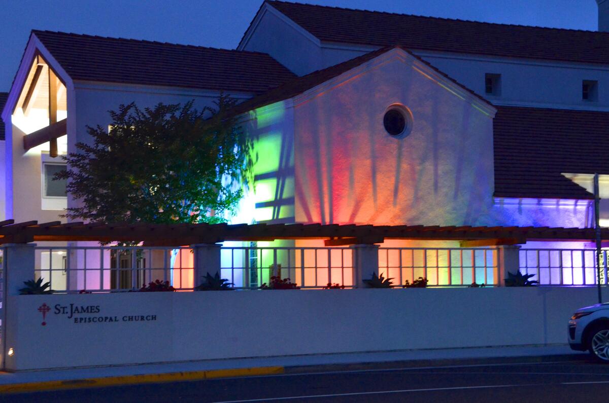 St. James Episcopal Church, Newport Beach shines rainbow lights on the outside church wall.