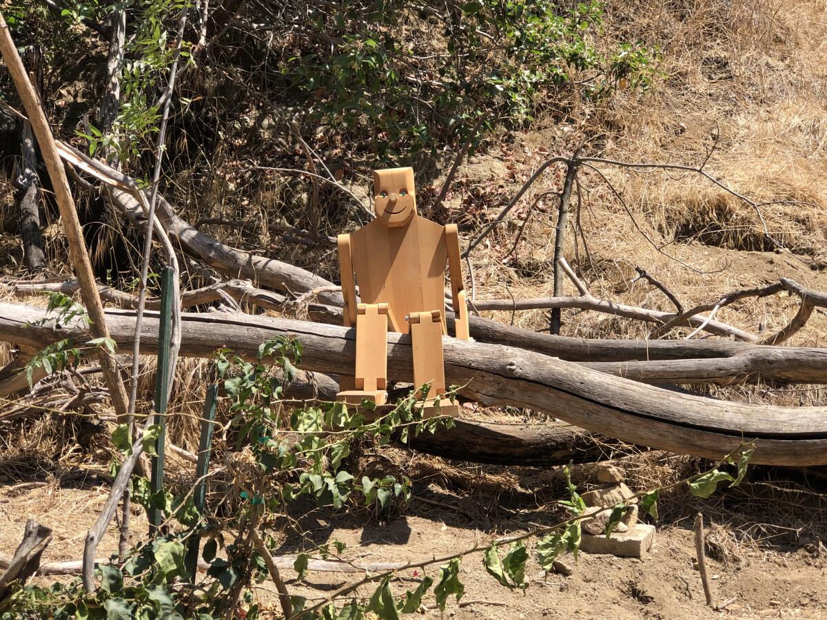 Just beyond Wattles Mansion is a little-trafficked canyon that has funky works of art strewn among the trails, including a wooden figure with marble eyes and a plaque with a smiling Buddha.