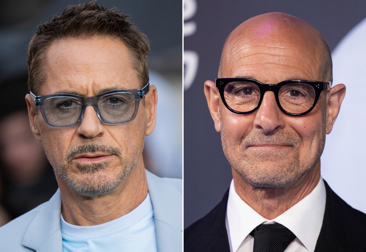 Robert Downey Jr. wears a blue blazer and blue tee with blue shades. Stanley Tucci wears a black suit. 