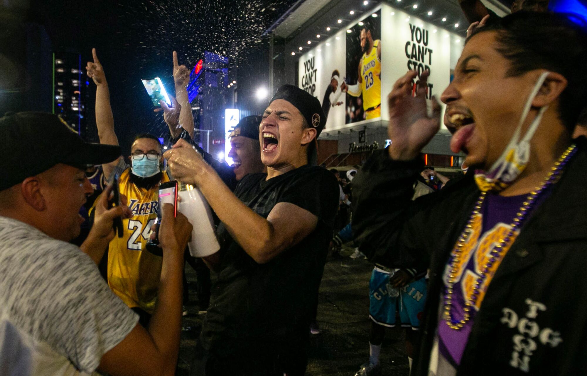 Fans gather near Staples Center to celebrate the Lakers’ NBA Finals win over the Miami Heat on Sunday.