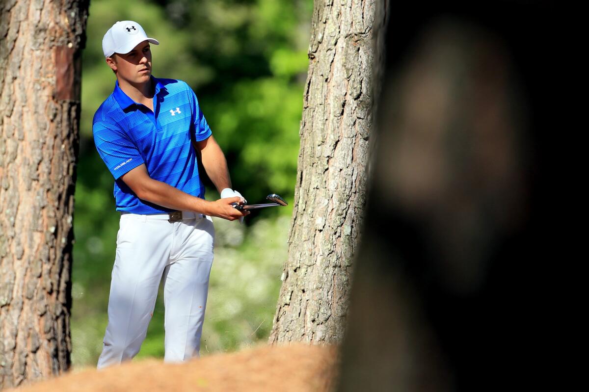 Jordan Spieth plays his second shot on the 11th hole from the trees during the final round of the Masters on Sunday.