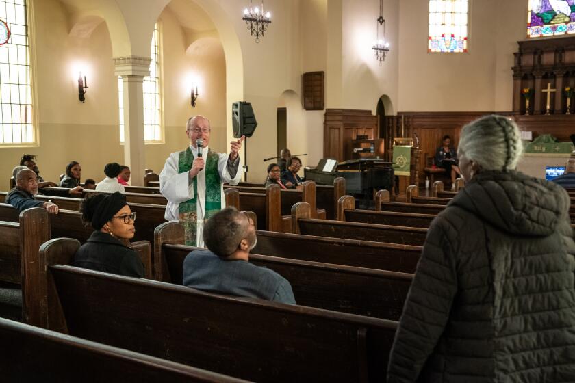 OAKLAND CA OCTOBER 22, 2023 -Pastor Todd Benson addresses a visitor during worship at Bethlehem Lutheran Church on Sunday, Oct. 22, 2023 in Oakland, California. The historically Black church's members have felt the impact of the housing crisis, as skyrocketing housing costs have pushed Black families out of the community. (Loren Elliott / For The Times)