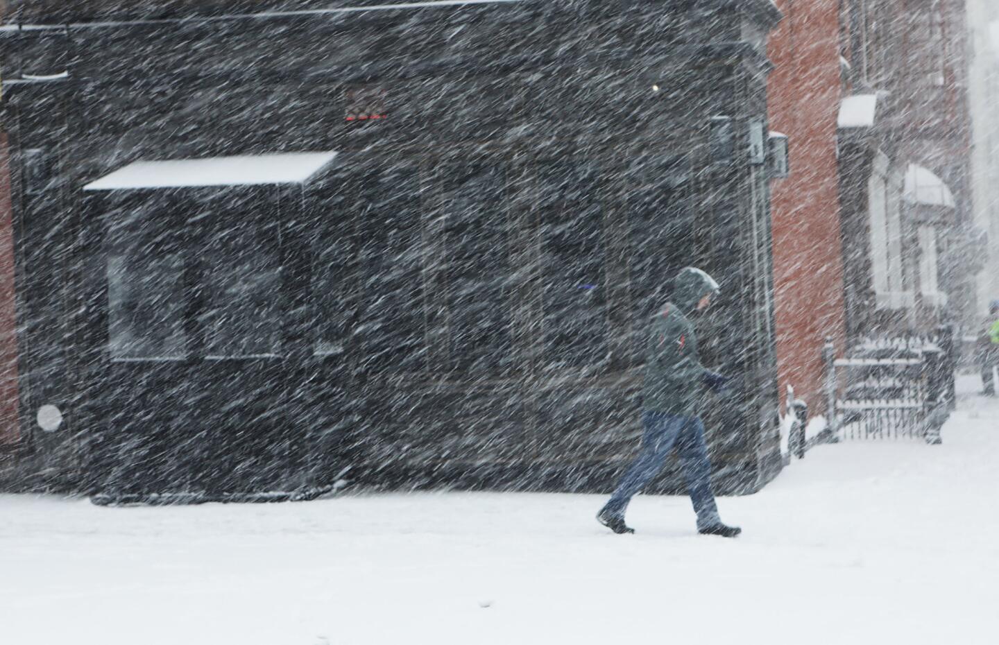 A pedestrian makes his way through the snow and wind in the Brooklyn borough of New York City.