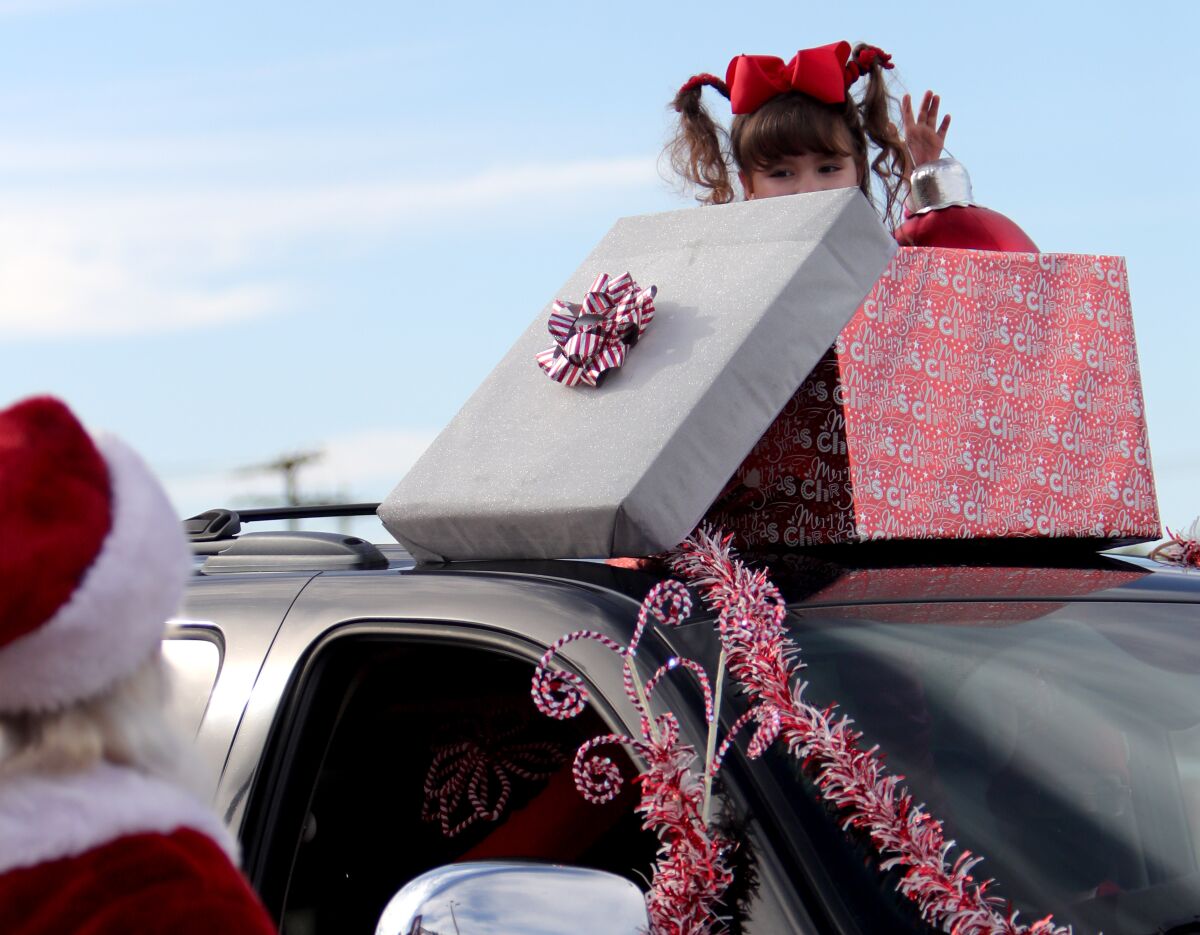 Santa Claus gets a shy wave from Brianna Johansen, 7,