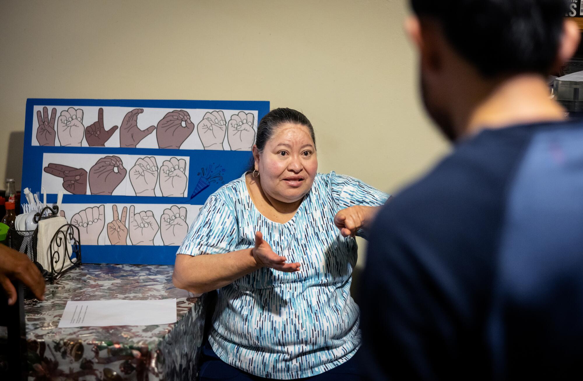 Maria Diaz, center, speaks to her son Javier, 32, right, after they were reunited at their home in South Los Angeles