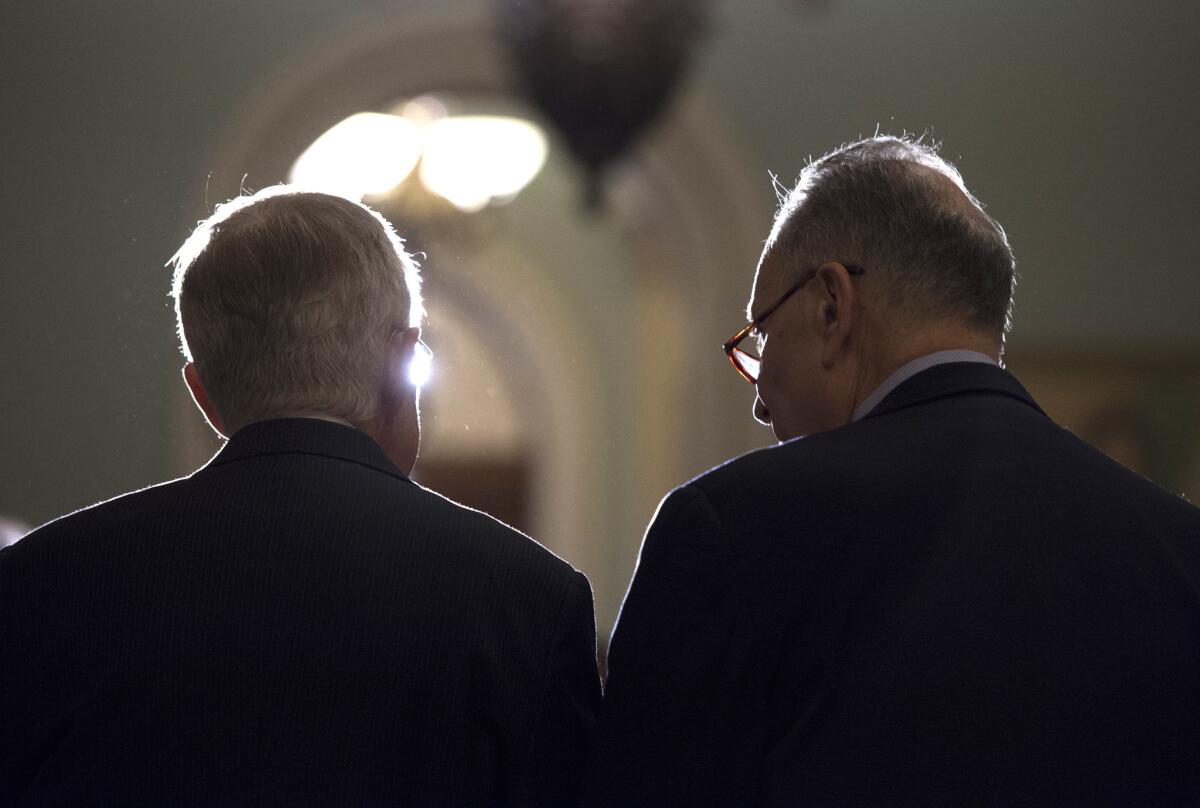 Senate Minority Leader Harry Reid (D-Nev.), left, and successor Sen. Charles E. Schumer (D-N.Y.) in Washington as Reid's last session wraps up.