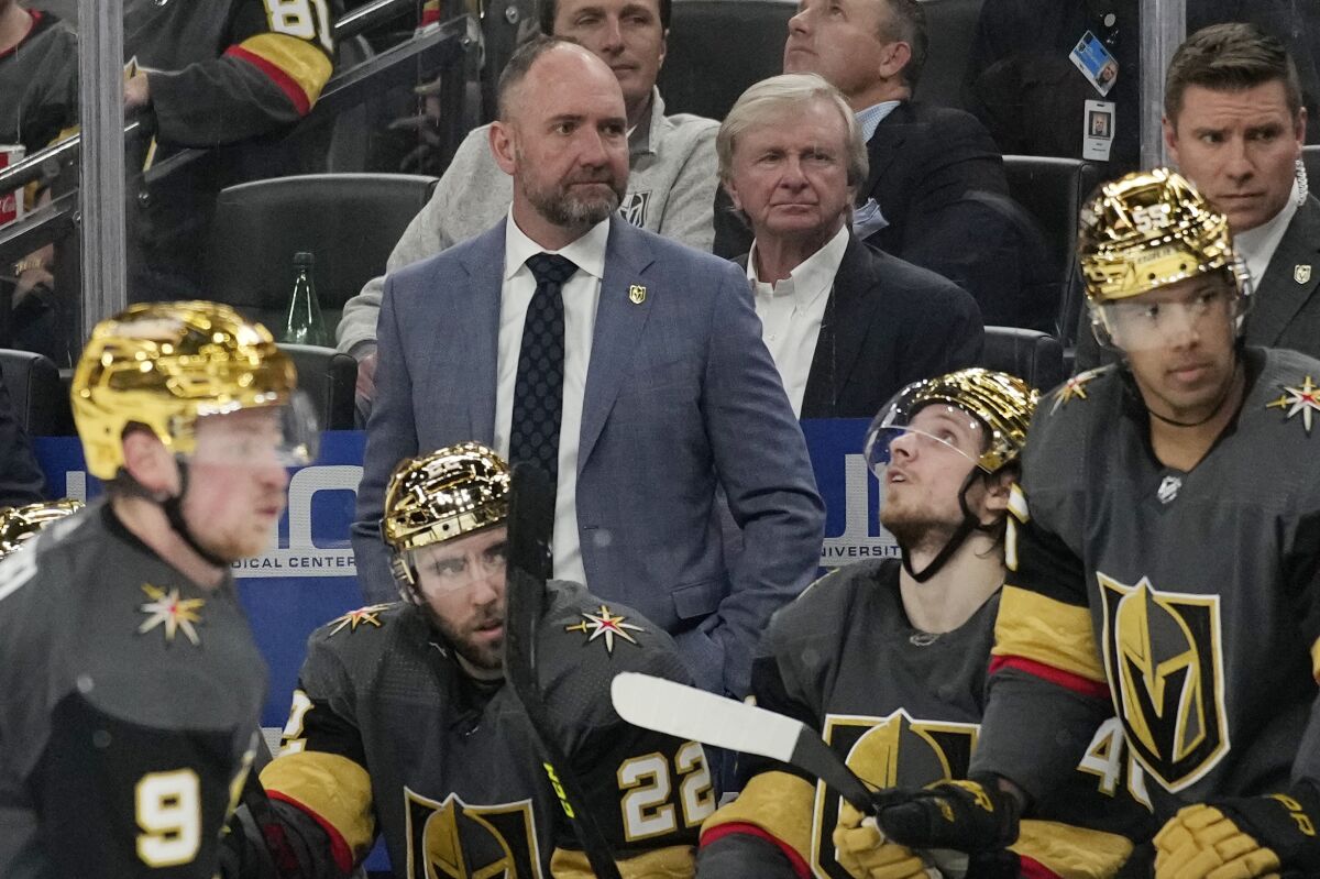 Vegas Golden Knights head coach Peter DeBoer, center, coaches during the third period of an NHL hockey game against the San Jose Sharks, Tuesday, March 1, 2022, in Las Vegas. (AP Photo/John Locher)