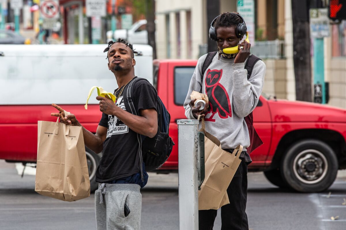 Two men leave a fruit swap in San Diego's City Heights neighborhood