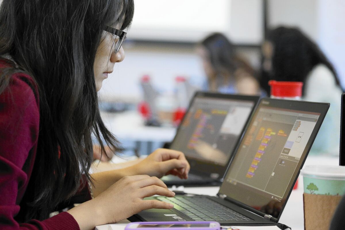 A student works during a Girls Who Code class at Adobe Systems in San Jose. The issue of teaching computer science in K-12 schools has picked up steam in politics and pop culture.
