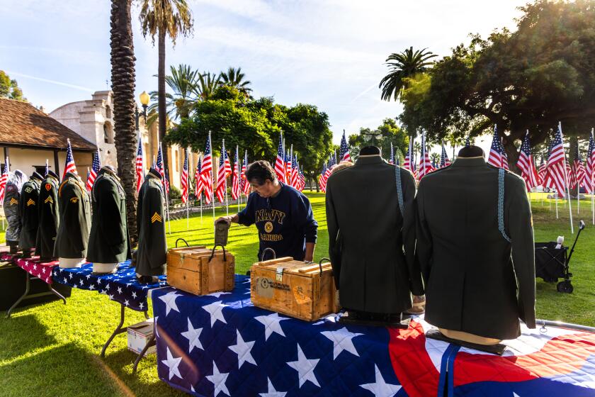 SAN GABRIEL, CA - NOVEMBER 10: Art Hernandez sets a display for Veterans Day ceremony held at Plaza Park on Friday, Nov. 10, 2023 in San Gabriel, CA. (Irfan Khan / Los Angeles Times)