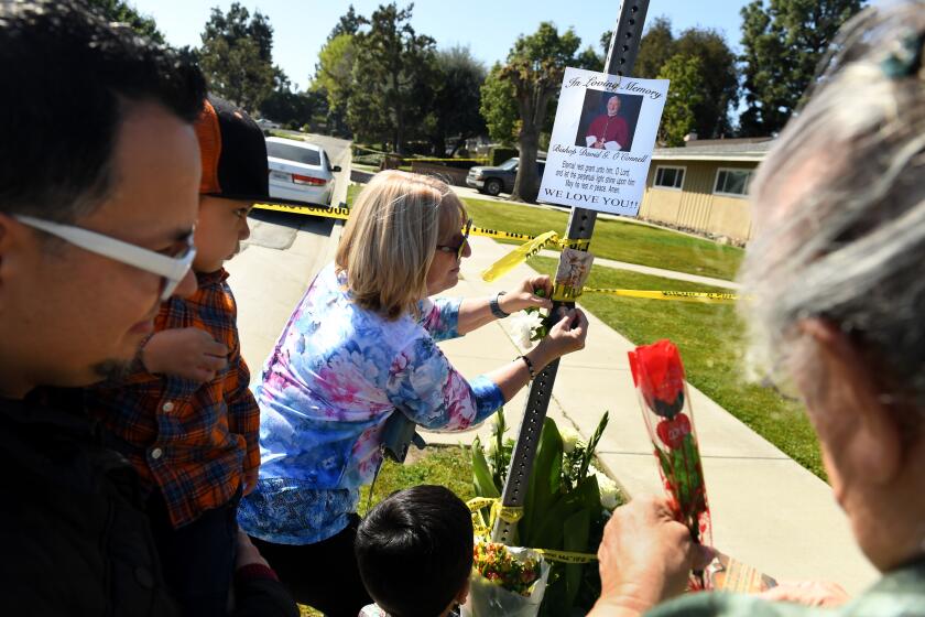 Hacienda Heights, California February 19, 2023- People place flowers near the house where Bishop David O'Connell was murdered in Hacienda Heights. (Wally Skalij/(Los Angeles Times)