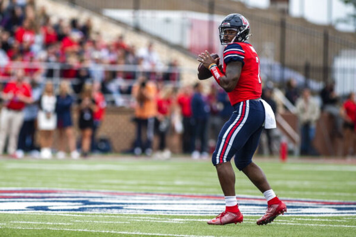 Liberty quarterback Malik Willis looks for a receiver during an NCAA college football game against Middle Tennessee State in Lynchburg, Va., Saturday, Oct. 9, 2021. (Kendall Warner/The News & Advance via AP)