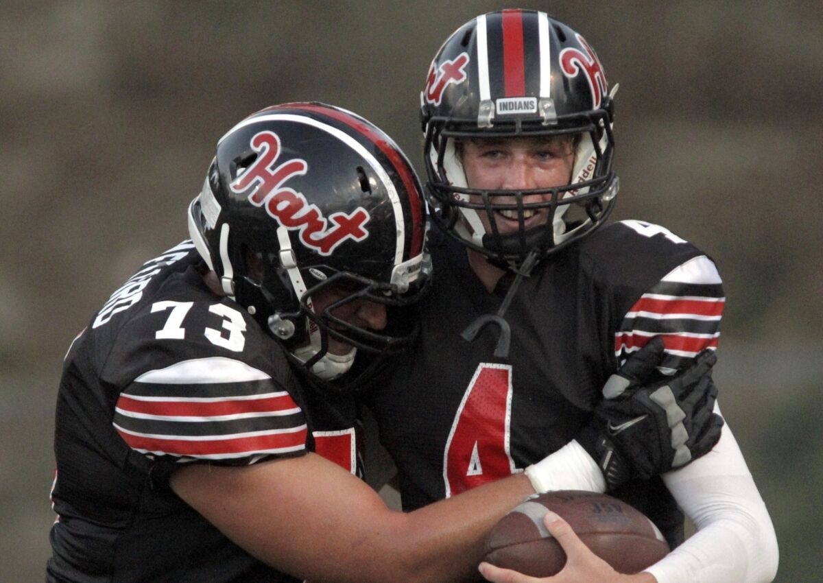 Erik Stafford, left, congratulates Trent Irwin after his touchdown during Hart's overtime victory against Chaminade.