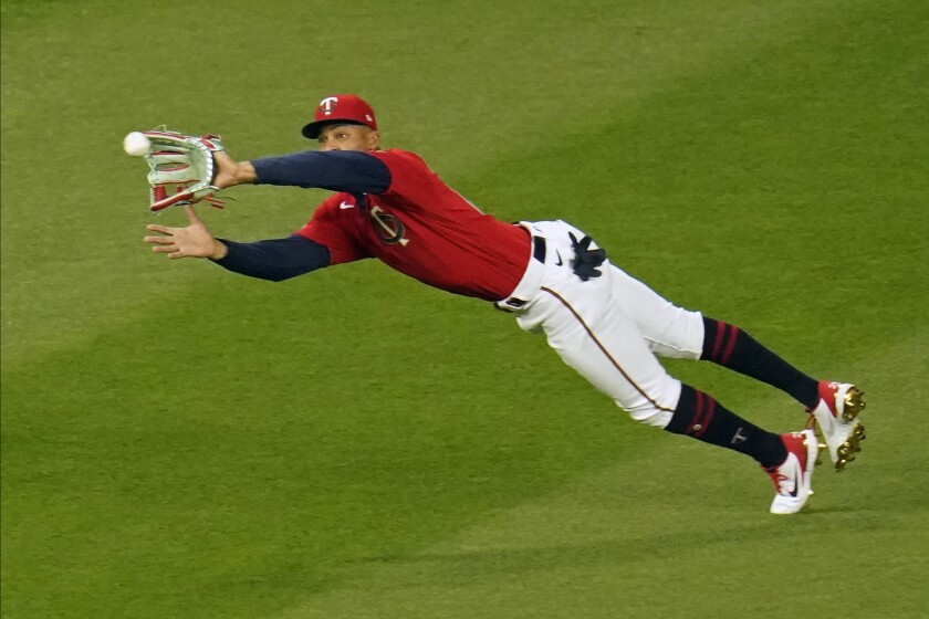 Minnesota Twins center fielder Byron Buxton makes a diving catch of a fly ball off the bat of Texas Rangers' David Dahl in the seventh inning of a baseball game, Tuesday, May 4, 2021, in Minneapolis. (AP Photo/Jim Mone)
