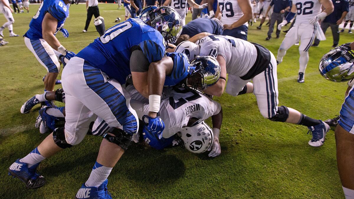 Memphis and Brigham Young players fight after the Tigers' double-overtime win in the Miami Beach Bowl on Monday.
