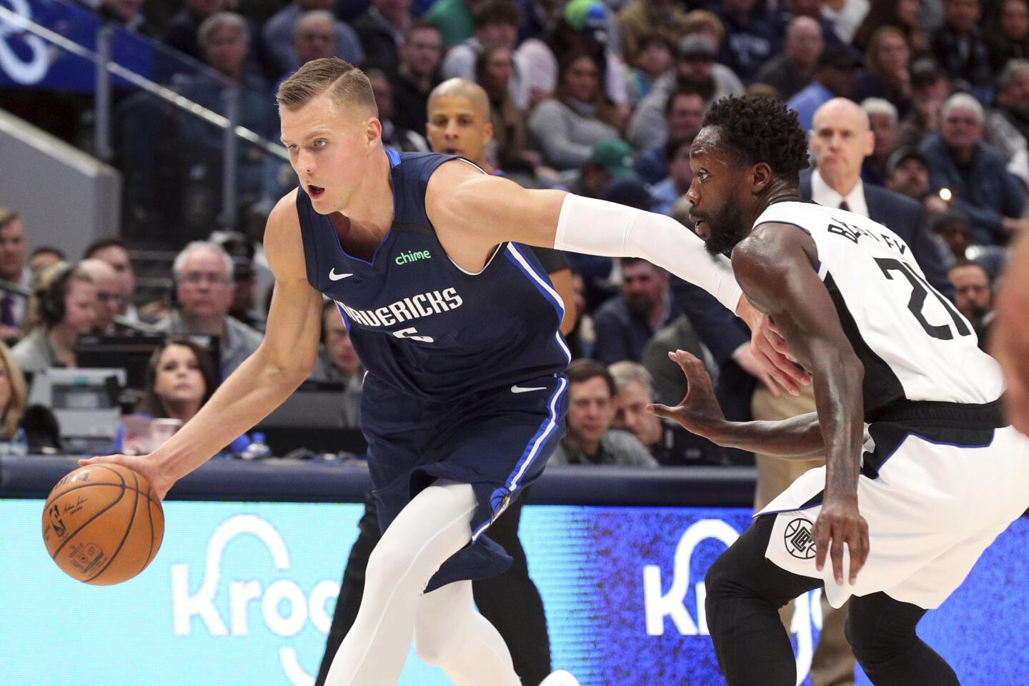 Mavericks forward Kristaps Porzingis drives against Clippers guard Patrick Beverley during the first half of a game Jan. 21.