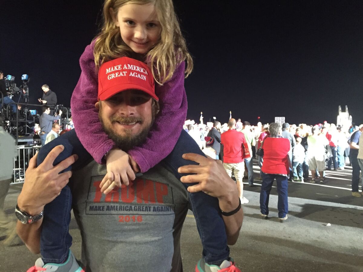 Justin Smith attends a Donald Trump rally in Kinston, N.C., with his daughter, Ella Lynn, 7,