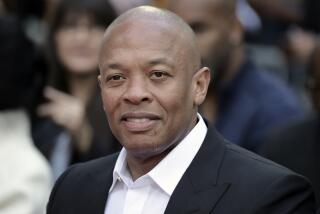 Dr. Dre smiles in a black suit at a 2018 hand and footprint ceremony honoring Quincy Jones in Los Angeles, Calif.