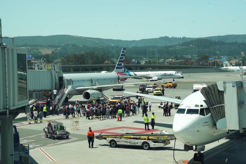 Three passengers aboard an American Airlines flight at San Francisco International Airport were injured Friday afternoon after they were forced to flee the aircraft on the runway after the cabin filled with smoke, officials said.