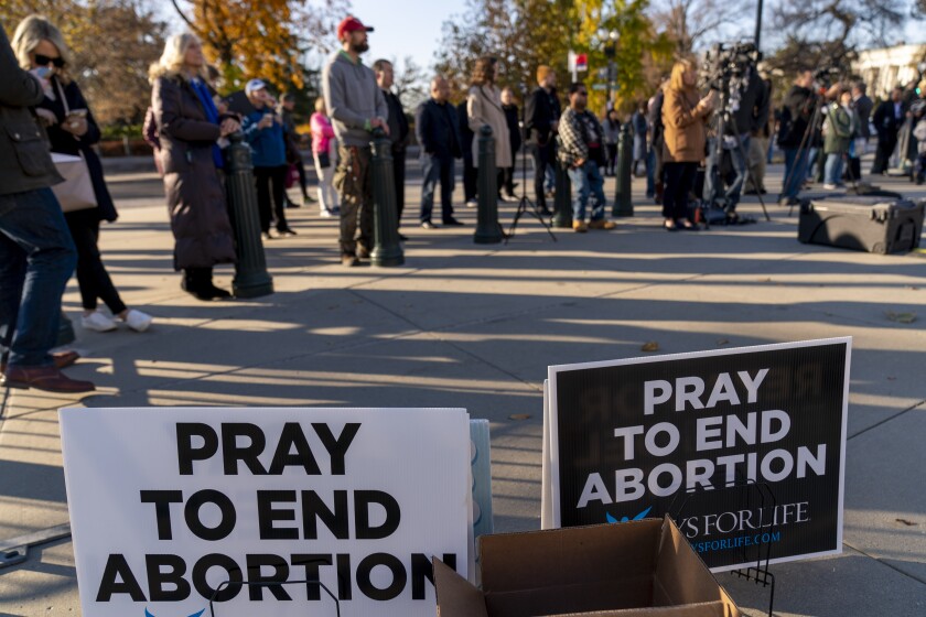 People listen during an anti-abortion rally outside of the Supreme Court in Washington, Tuesday, Nov. 30, 2021, as activists begin to arrive ahead of arguments on abortion at the court in Washington.(AP Photo/Andrew Harnik)