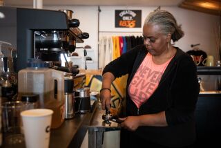 San Diego, California - March 01: Cynthia Ajani makes a coffee at Cafe X: By Any Beans Necessary on Tuesday, March 1, 2022 in San Diego, California. Ajani recently opened the business with her daughter. The coffee shop is part of a co-operative called 1835 Studios which also has clothing stores, a barber and art gallery. (Ana Ramirez / The San Diego Union-Tribune)