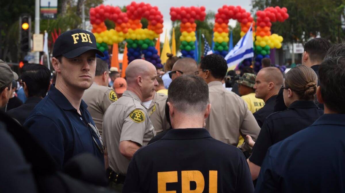 FBI agents keep watch during the L.A. Pride parade in West Hollywood on Sunday.