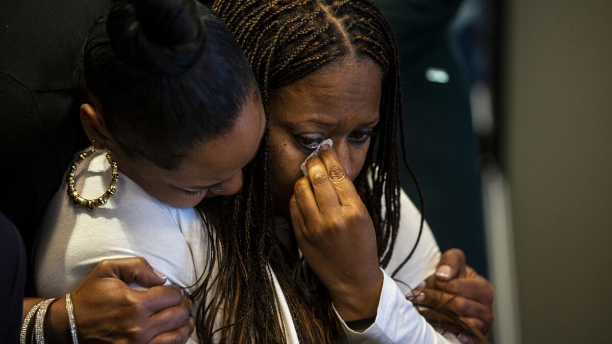 Pride Franklin, left, hugs Cherie Townsend after speaking during a news conference Monday. Townsend was accused of murder after visiting the Promenade on the Peninsula shopping center the same day retired nurse Susan Leeds, 66, was found stabbed in her Mercedes in May.