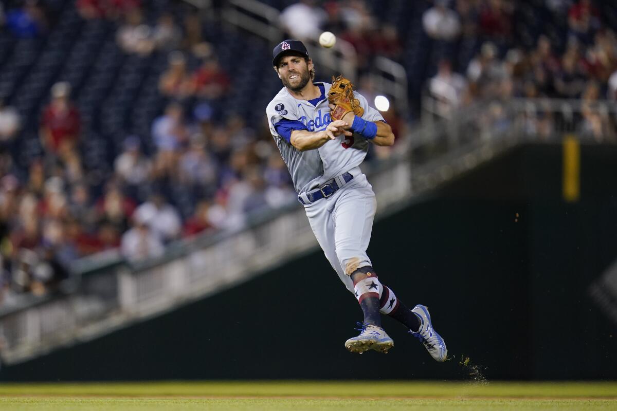 Chris Taylor leaps and makes a throw.