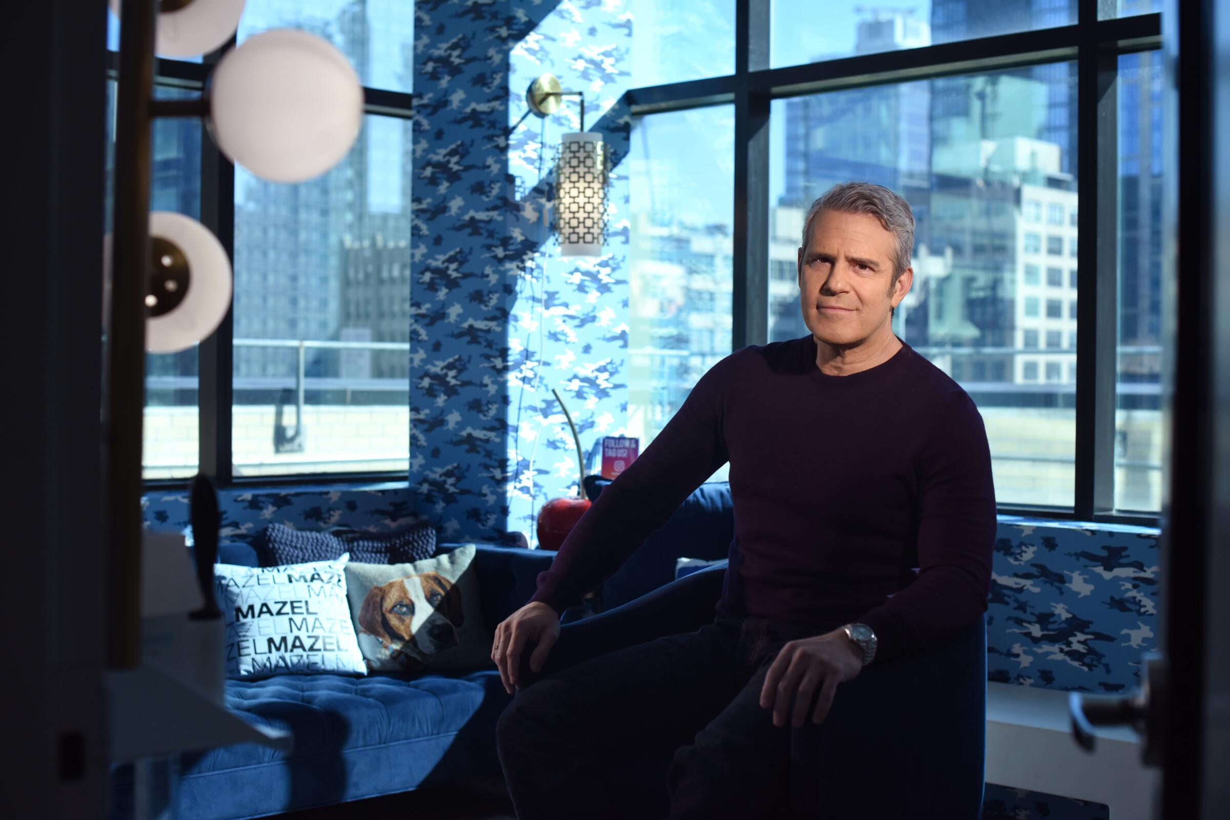 A man in a sweater sitting in a chair