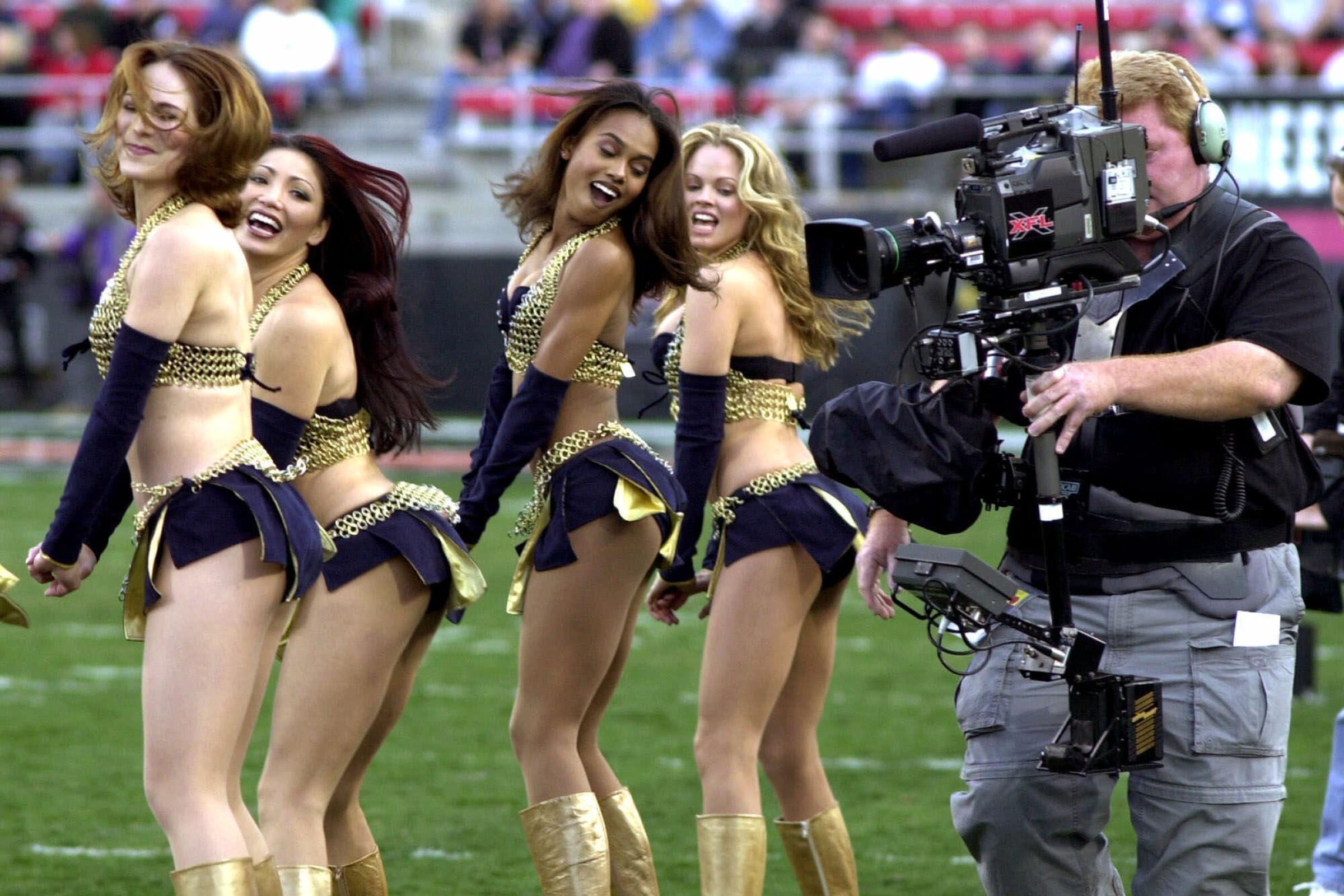 A television cameraman photographs the Los Angeles Xtreme cheerleaders before an XFL game in 2001.