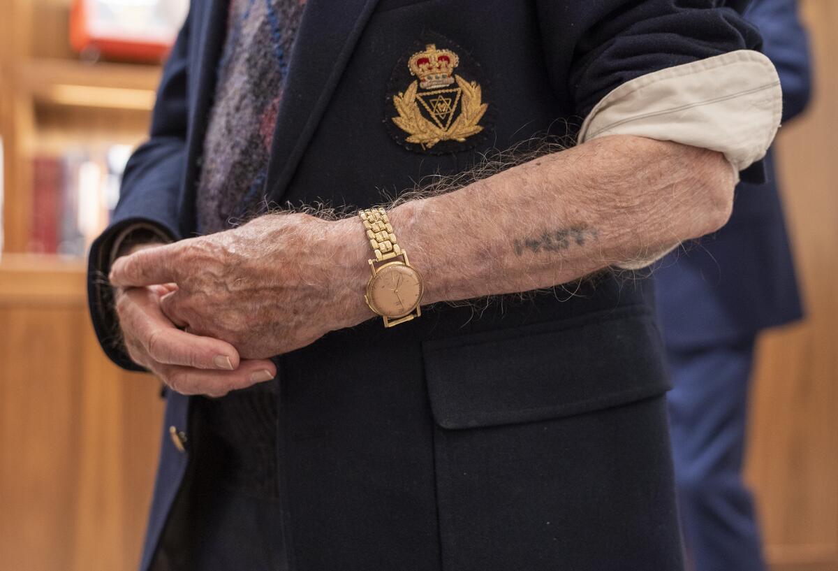 Joseph Alexander shows the tattoo on his arm that was put on him when he was sent to a concentration camp by the Nazis.