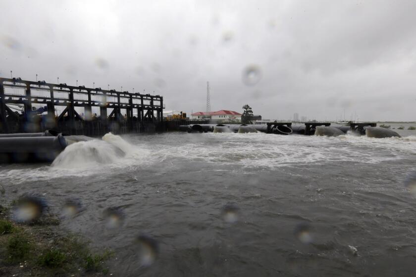 Water flows out of the new 17th Street Canal pumping station as Hurricane Isaac hits in New Orleans.