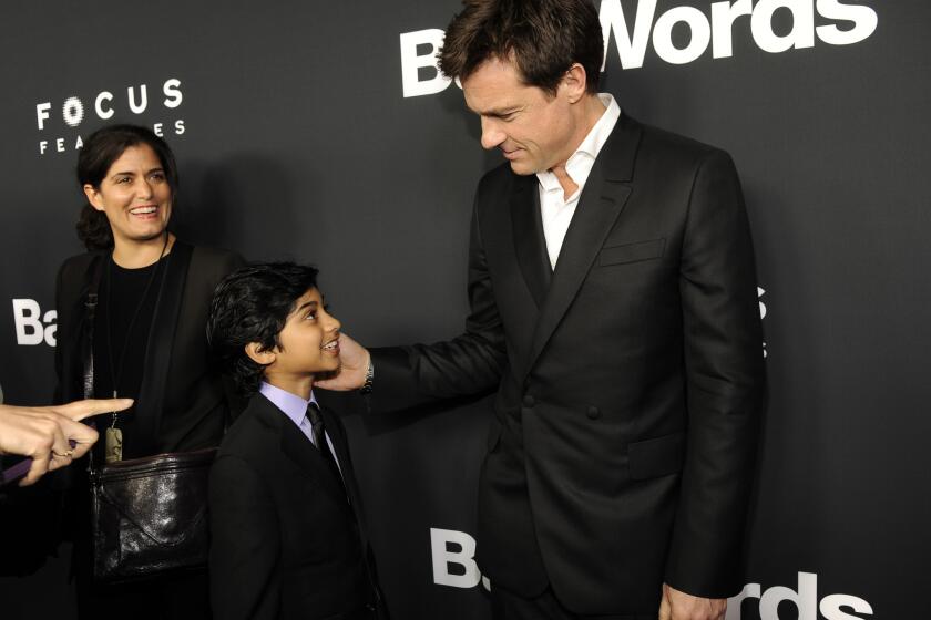 Jason Bateman, right, director and a cast member in "Bad Words," greets young cast member Rohan Chand at the premiere of the film on March 5, 2014, in Los Angeles.