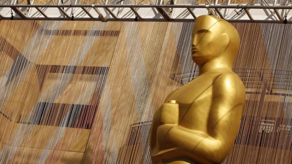 A colorful chain curtain is the backdrop for a giant Oscar statue at Hollywood and Highland earlier this year.