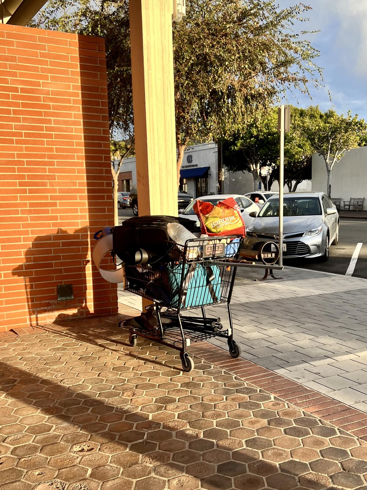 A homeless person's belongings fill a shopping cart in La Jolla's Village.