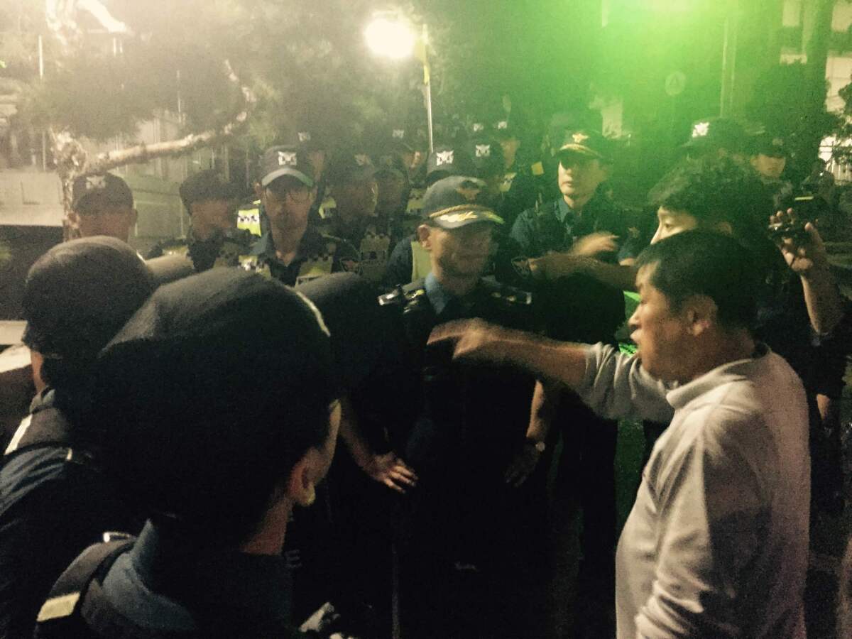 Mourners argue with South Korean riot police outside the Seoul National University Hospital funeral home in Seoul on Sep. 25, 2016.