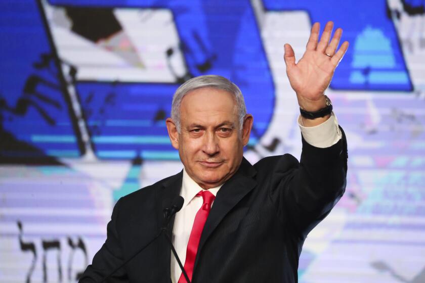 Israeli Prime Minister Benjamin Netanyahu waves to his supporters after the first exit poll results for the Israeli parliamentary elections at his Likud party's headquarters in Jerusalem, Wednesday, March. 24, 2021. (AP Photo/Ariel Schalit)